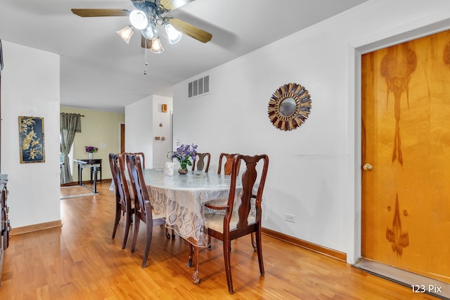 dining area with ceiling fan and light hardwood / wood-style flooring