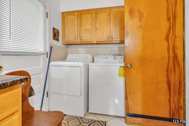 laundry area with light tile patterned floors and independent washer and dryer