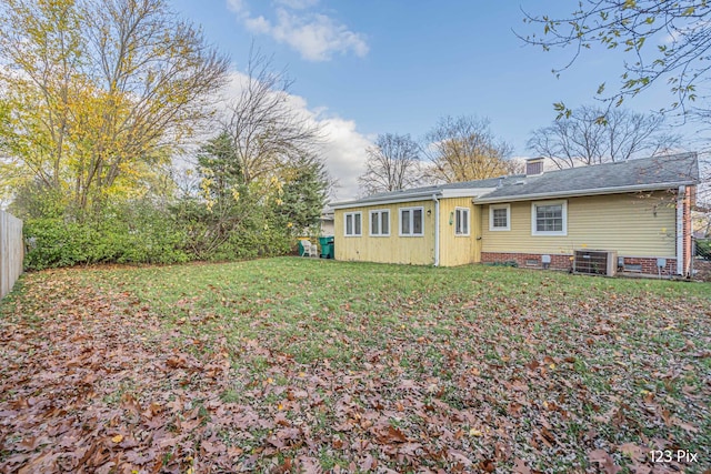 rear view of house featuring a lawn