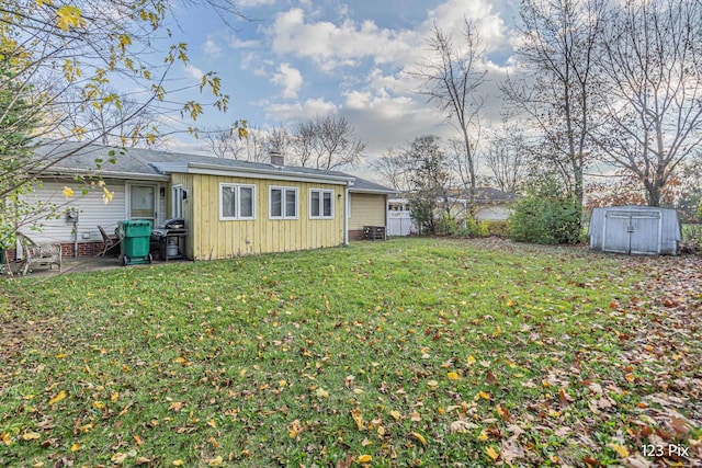 back of house with a chimney, central air condition unit, fence, a yard, and a shingled roof