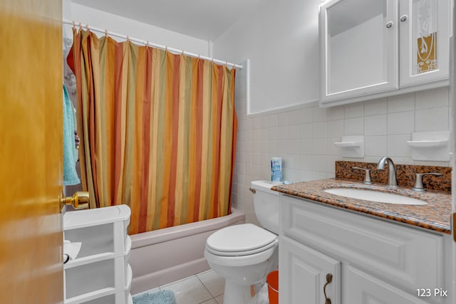 full bathroom featuring shower / tub combo, tile patterned floors, vanity, tile walls, and toilet