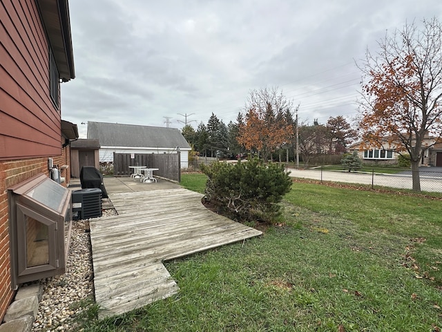 view of yard with central AC unit and a wooden deck