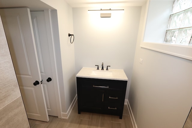 bathroom with hardwood / wood-style floors and vanity