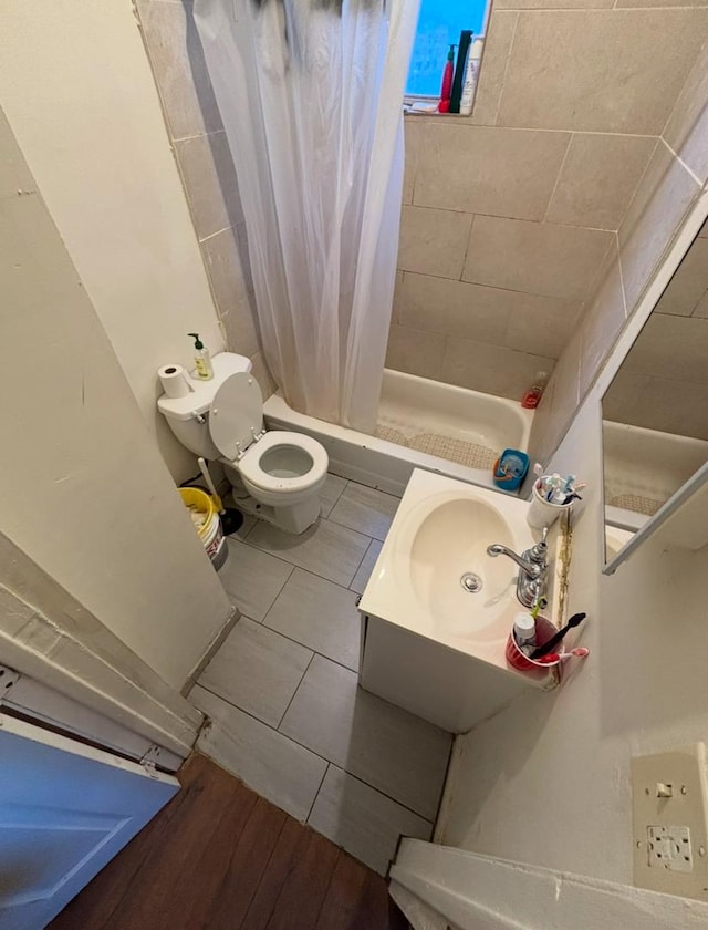 bathroom featuring tile patterned floors, toilet, sink, and walk in shower