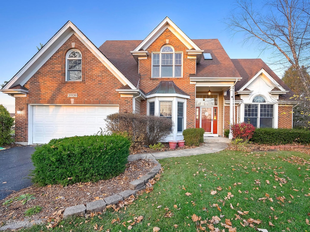 front of property with a front yard and a garage