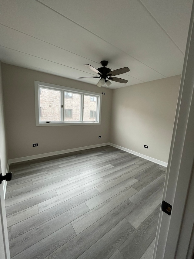 spare room featuring ceiling fan and light hardwood / wood-style flooring