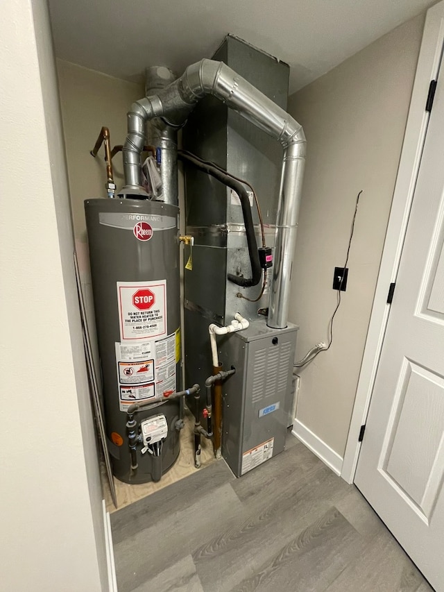 utility room featuring heating unit and water heater