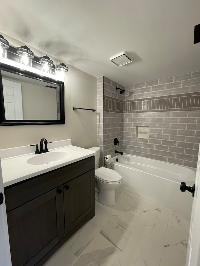 full bathroom featuring vanity, toilet, and tiled shower / bath