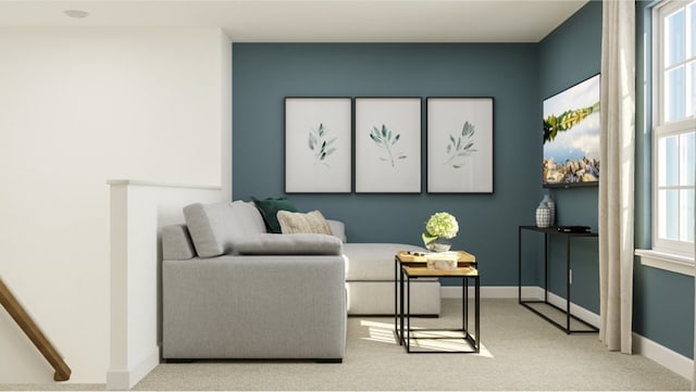 sitting room featuring a wealth of natural light and light carpet