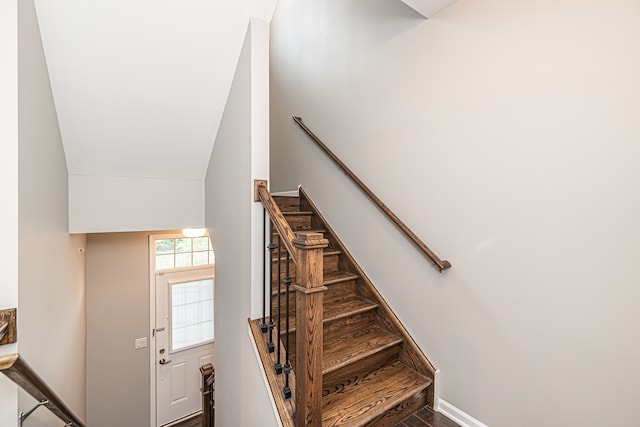 staircase with vaulted ceiling