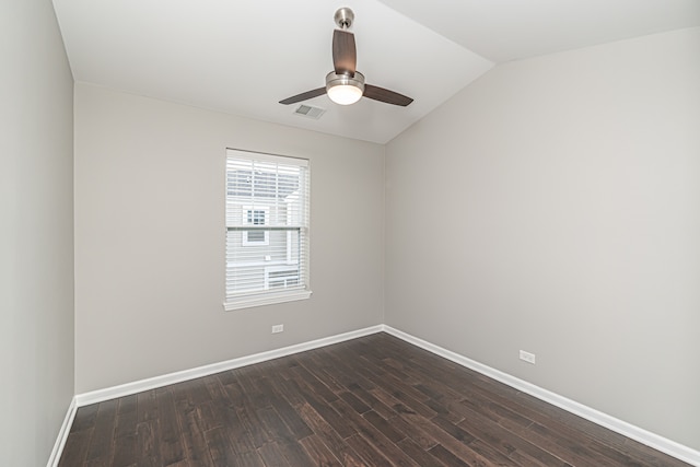 empty room featuring ceiling fan, dark wood-type flooring, and vaulted ceiling