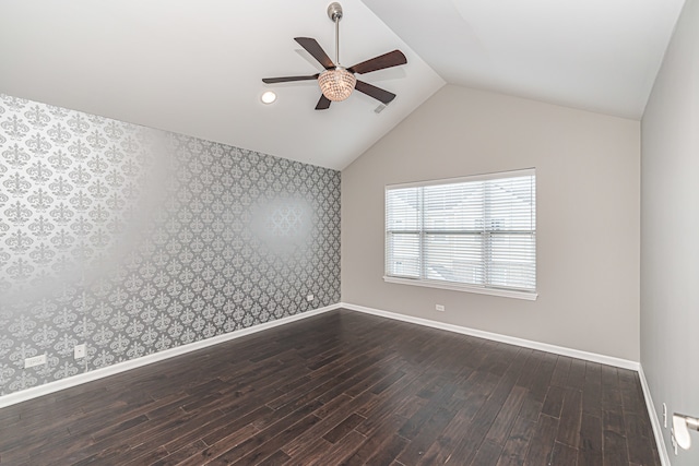 empty room featuring vaulted ceiling, ceiling fan, and dark hardwood / wood-style floors