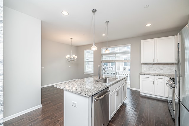 kitchen with light stone countertops, sink, white cabinets, and stainless steel appliances