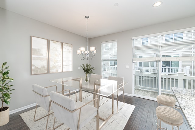 dining area featuring a chandelier and dark wood-type flooring