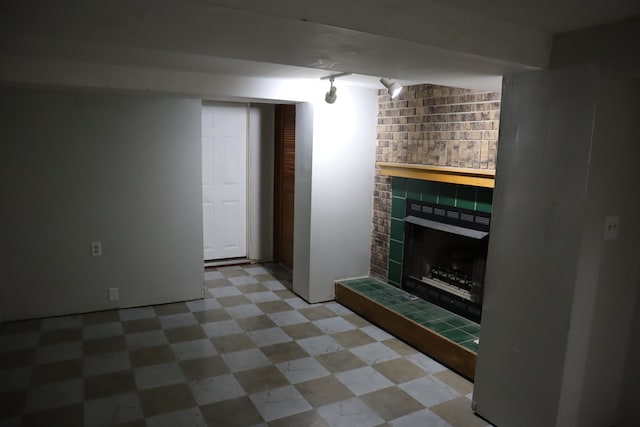 unfurnished living room featuring a tile fireplace