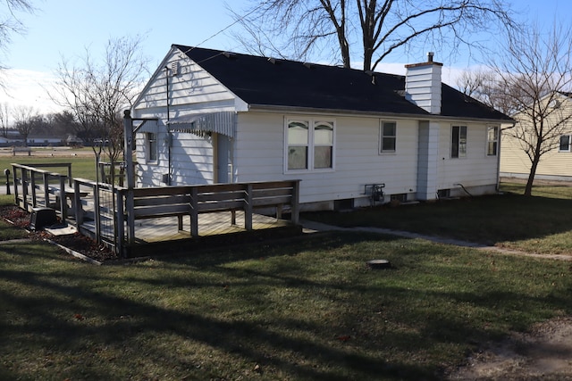 back of house featuring a deck and a yard