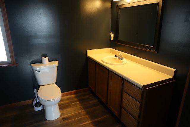 bathroom featuring hardwood / wood-style floors, vanity, and toilet