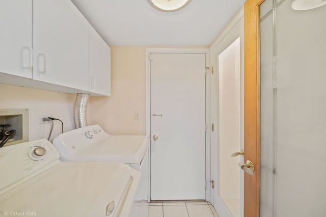 laundry room featuring light tile patterned flooring, cabinet space, and separate washer and dryer