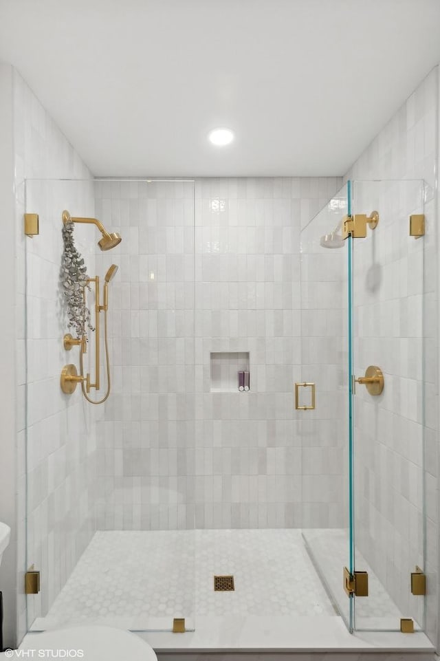 bathroom with a stall shower and toilet