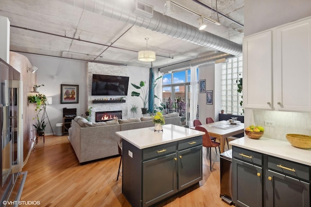 kitchen featuring white cabinets, light countertops, and light wood finished floors