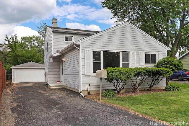 517 Grandview Dr, Round Lake Park, IL 60073 - view of front of home with an outdoor structure, a chimney, a garage, and a front yard
