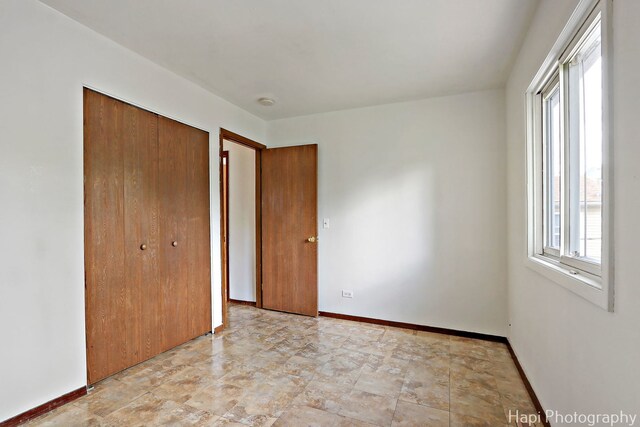 517 Grandview Dr, Round Lake Park, IL 60073 - unfurnished bedroom featuring a closet and baseboards