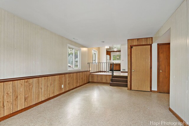 517 Grandview Dr, Round Lake Park, IL 60073 - unfurnished room featuring light floors, baseboards, and wood walls