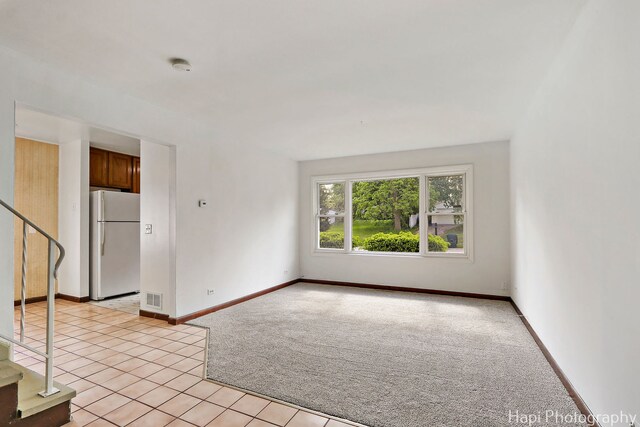 517 Grandview Dr, Round Lake Park, IL 60073 - unfurnished room with light colored carpet, stairway, light tile patterned floors, baseboards, and a smoke detector