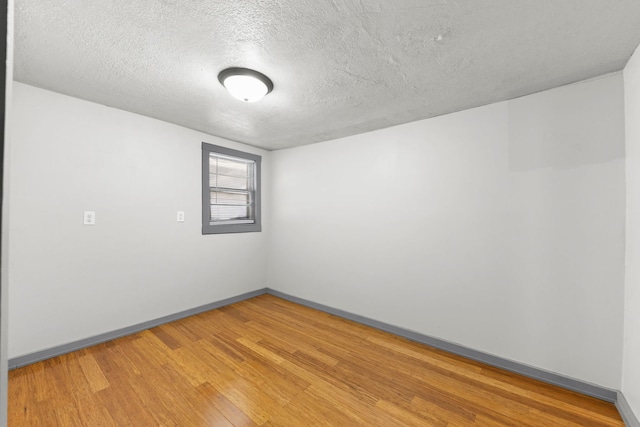 1326 Arthur Ave, Joliet, IL 60432 - unfurnished room featuring a textured ceiling, baseboards, and light wood-style floors