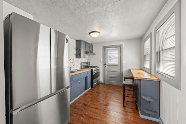 1326 Arthur Ave, Joliet, IL 60432 - kitchen featuring stainless steel appliances, wood counters, a sink, under cabinet range hood, and dark wood-style flooring