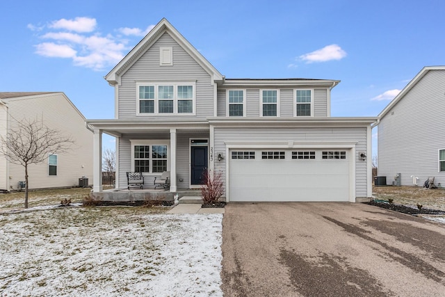 view of front of property featuring a front yard, a porch, and a garage