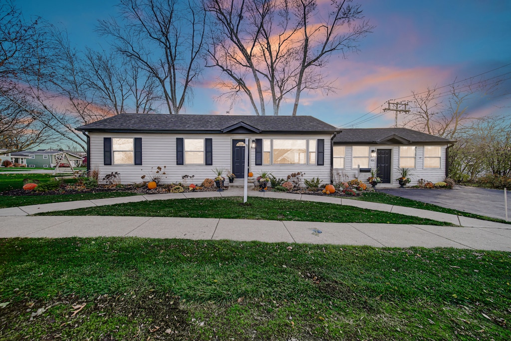 single story home with a lawn