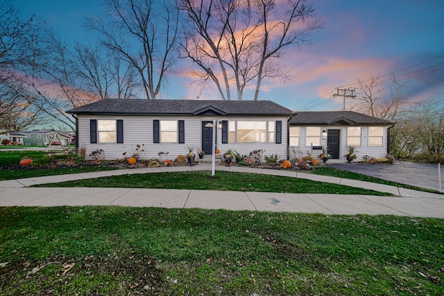 single story home with a lawn