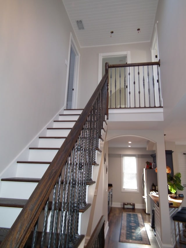 staircase with hardwood / wood-style floors