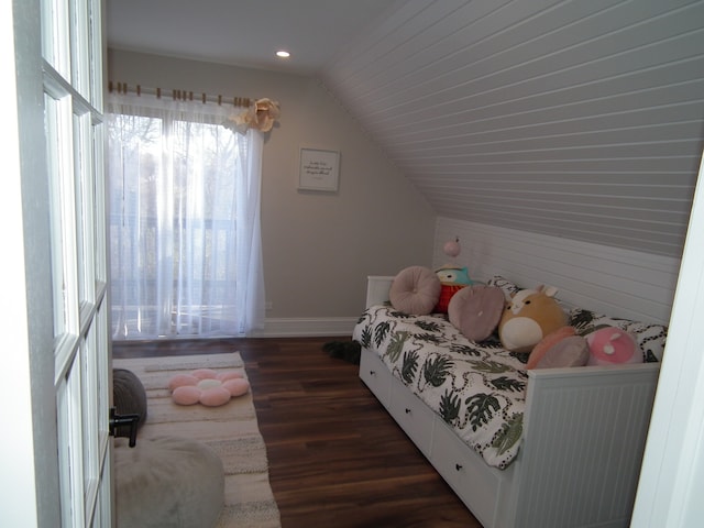 bedroom with dark hardwood / wood-style floors and lofted ceiling