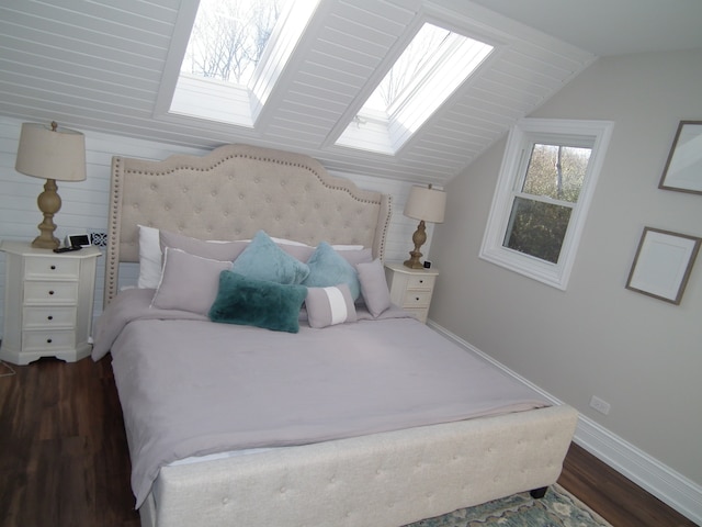 bedroom featuring dark hardwood / wood-style floors and lofted ceiling with skylight