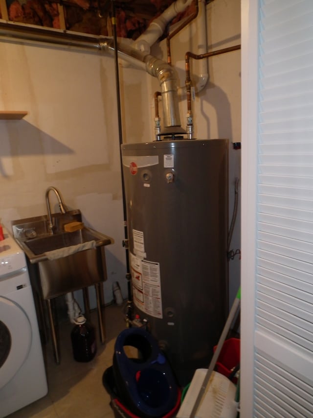 utilities featuring gas water heater, sink, and washer / clothes dryer