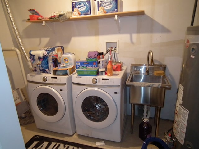 laundry area with separate washer and dryer, gas water heater, and sink