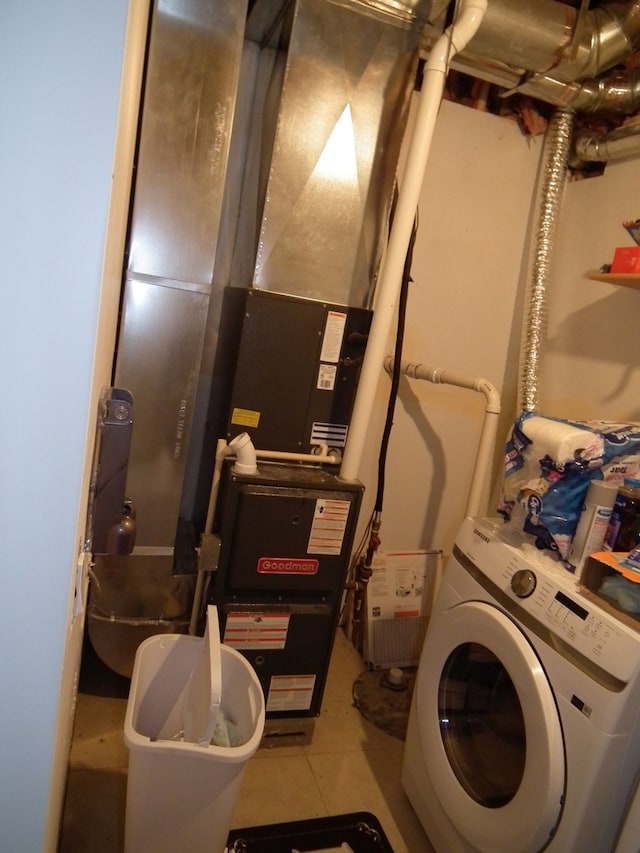 laundry room featuring tile patterned floors and washer / clothes dryer