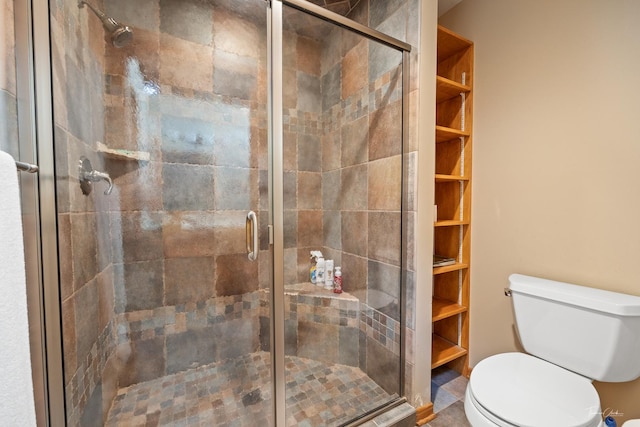 bathroom featuring toilet and walk in shower