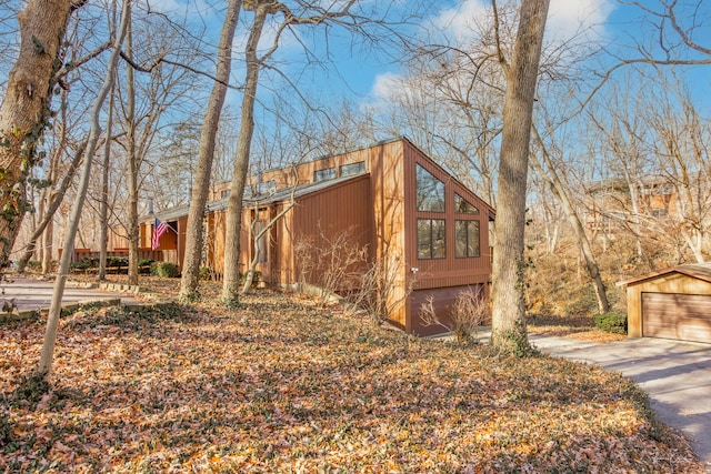 view of property exterior featuring a garage and an outdoor structure