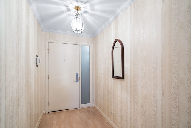 doorway featuring light wood-type flooring and ornamental molding