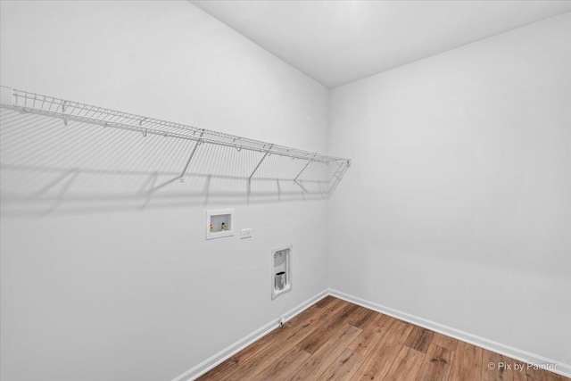 washroom with washer hookup, hardwood / wood-style flooring, and electric dryer hookup