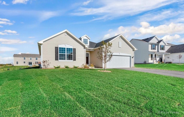 view of front of house featuring a front lawn and a garage