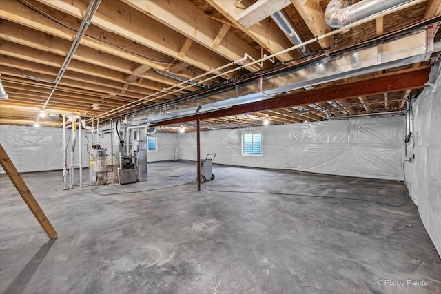 basement featuring water heater and heating unit