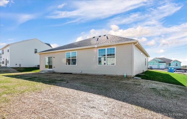 rear view of property with a lawn