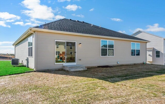 rear view of house featuring a lawn