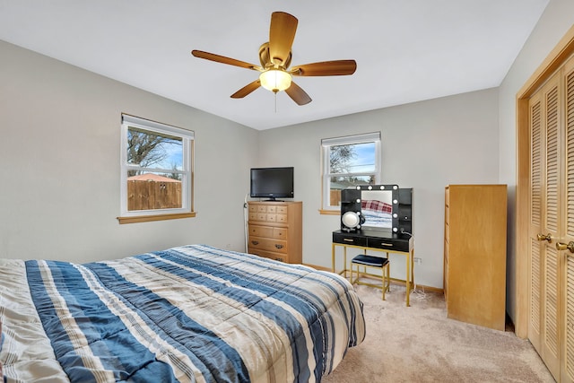 carpeted bedroom with a closet and ceiling fan