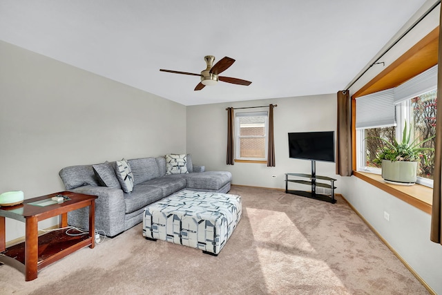 carpeted living room with ceiling fan