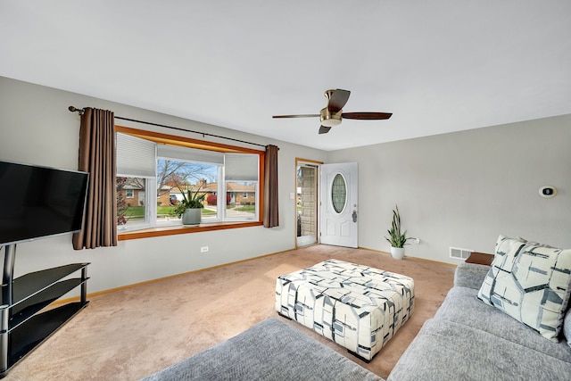 living room with ceiling fan and light colored carpet